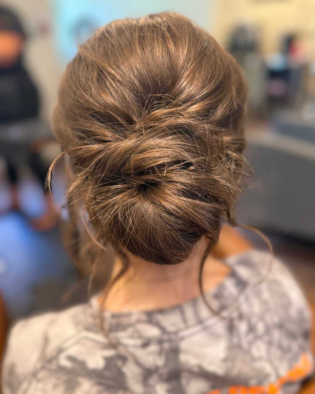 Elegant updo hairstyle with loose curls in a casual setting.