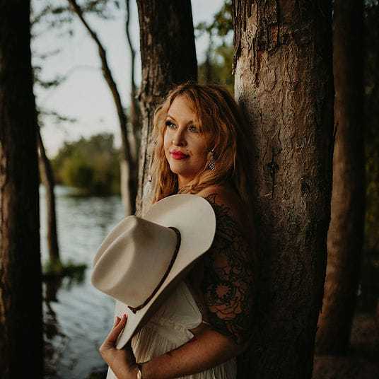 Portrait of Tanya Noir, a professional stylist at 4 North Beauty Collective, showcasing their expertise and style.